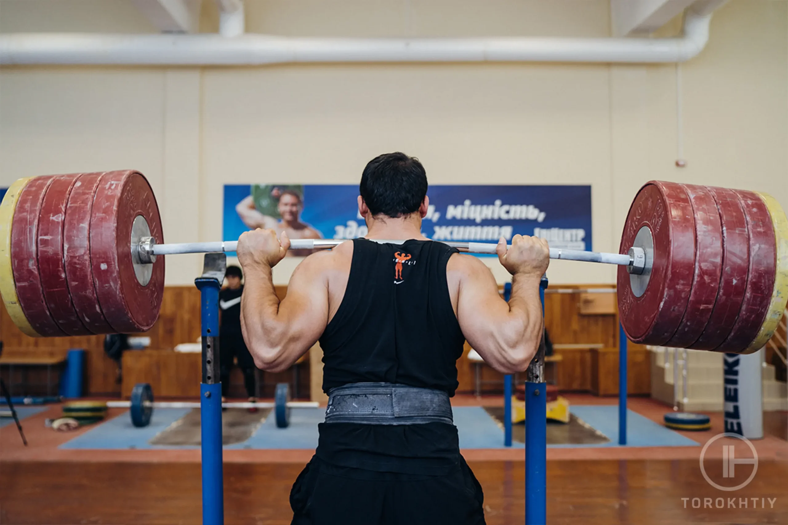 athlete lifts heavy barbell