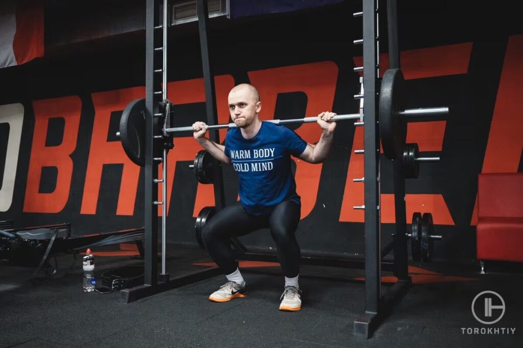 athlete training on smith machine