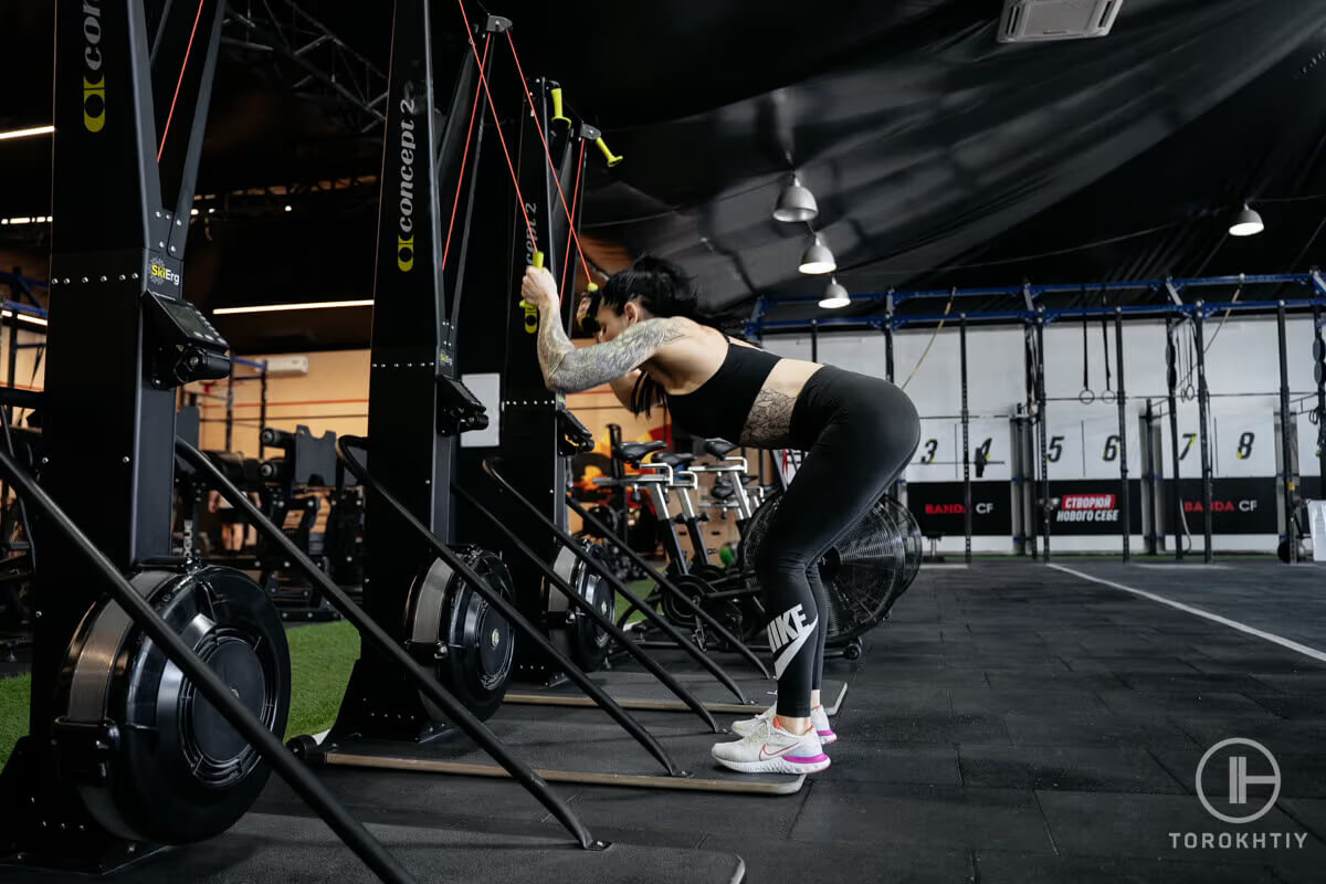 Concept2 skierg in gym and woman athelete