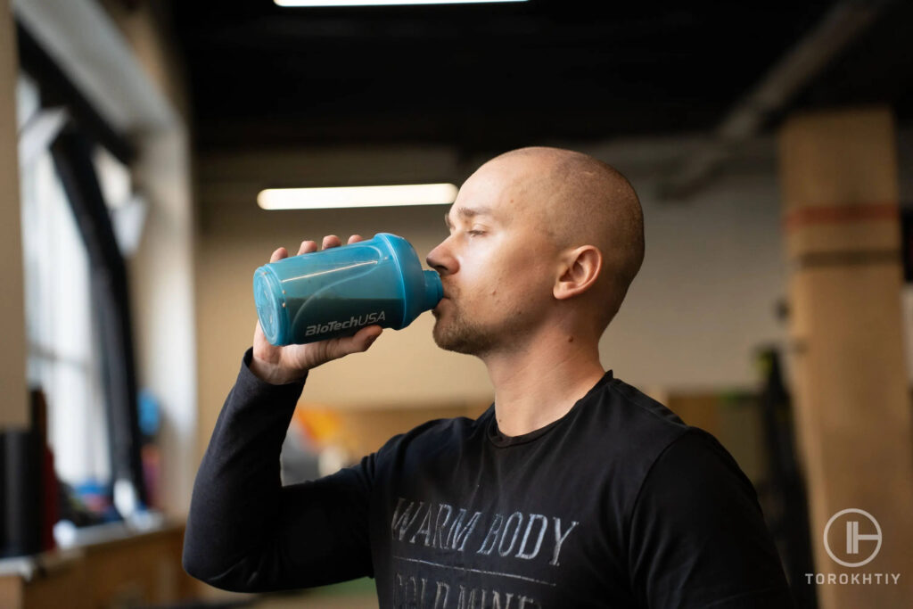 man drinks supplement shake