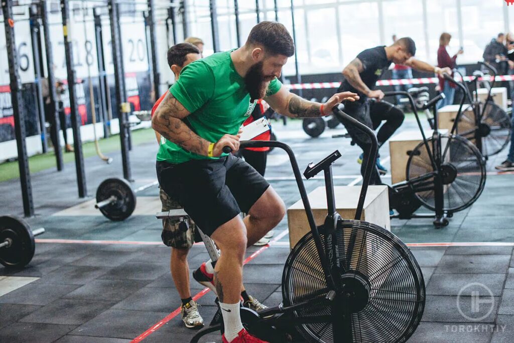 man exercises on air bike