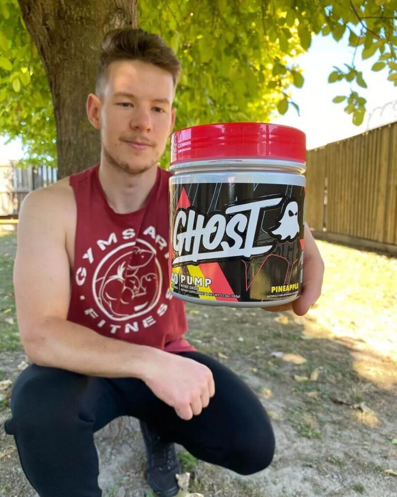 man holds ghost supplement bottle