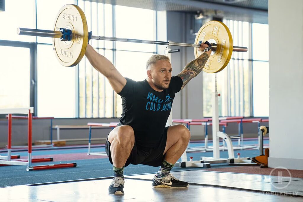 athlete lifts barbell