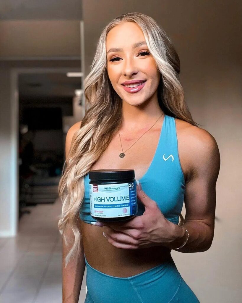 athlete woman shows pescience supplement bottle