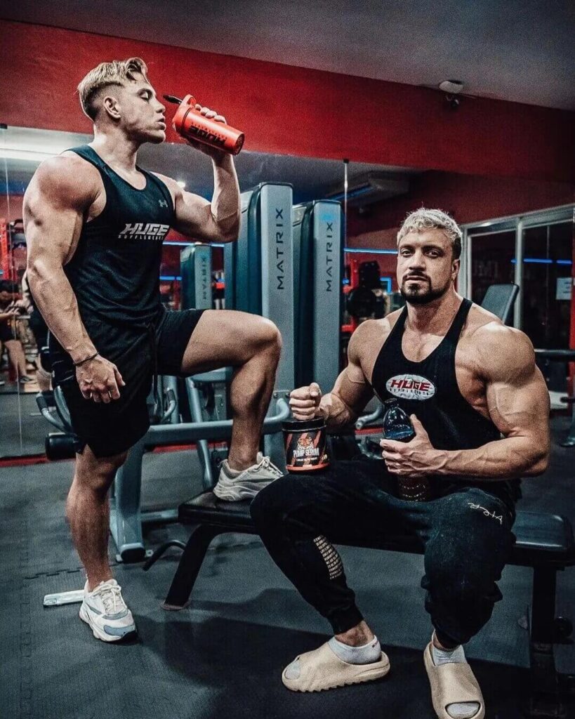 athletes drink supplement shake in gym